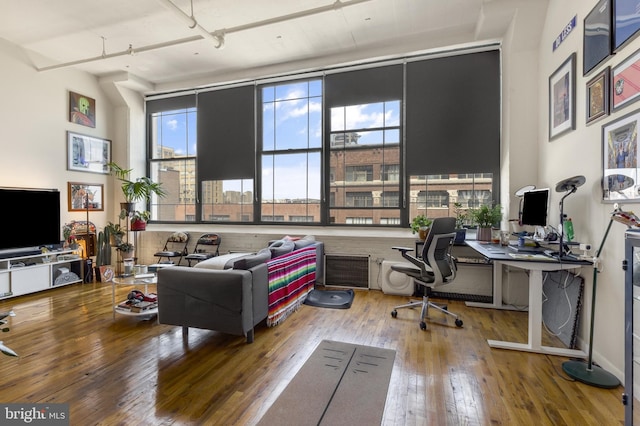 office area featuring hardwood / wood-style floors and a high ceiling