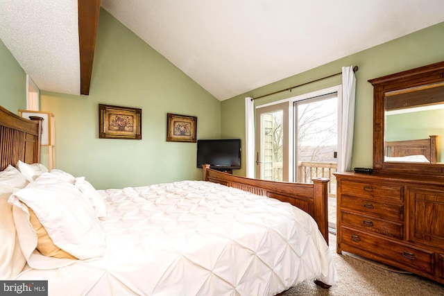 bedroom with vaulted ceiling and carpet flooring