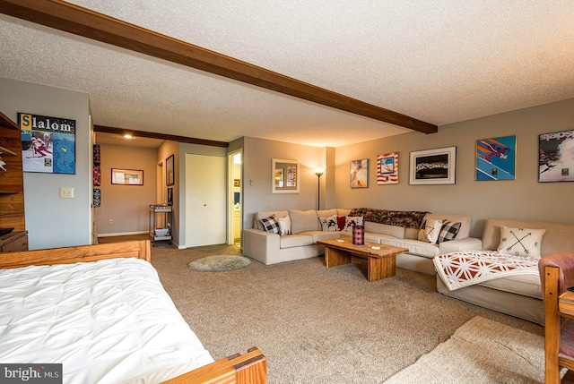 living room with a textured ceiling, beam ceiling, and carpet floors