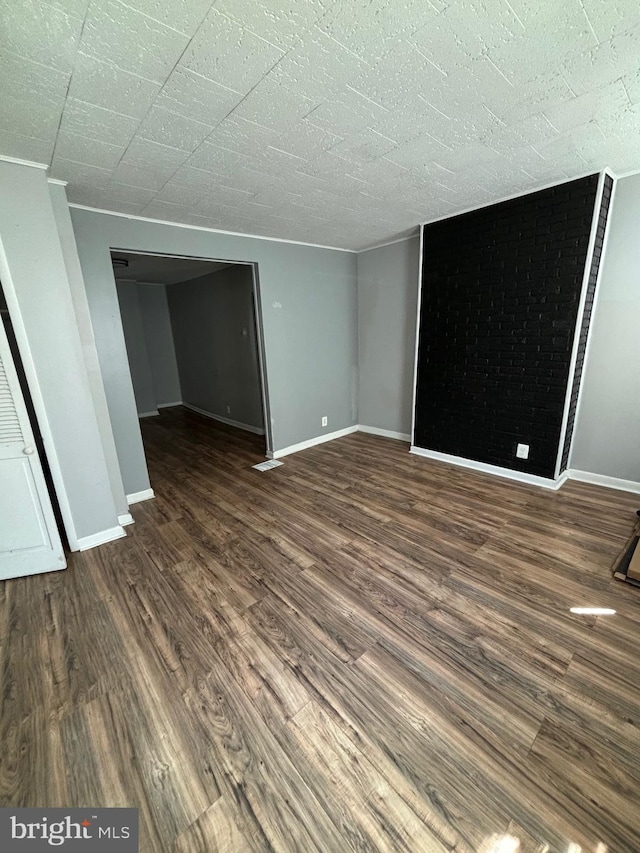 unfurnished room with dark hardwood / wood-style flooring