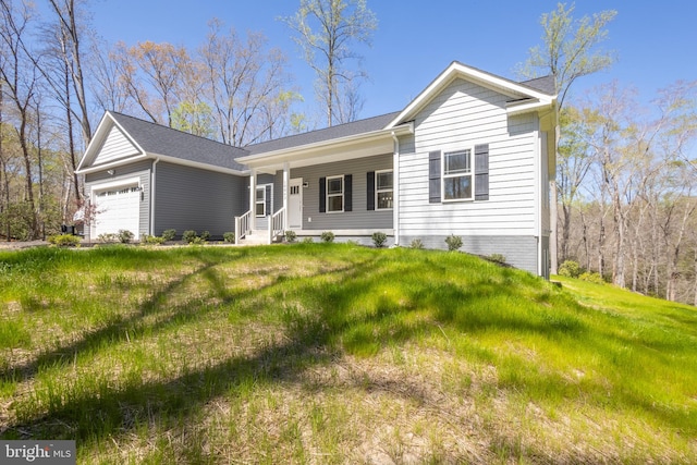 ranch-style house featuring a garage and a front lawn