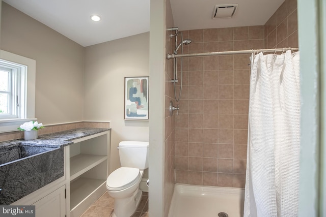 bathroom with walk in shower, toilet, and tile floors