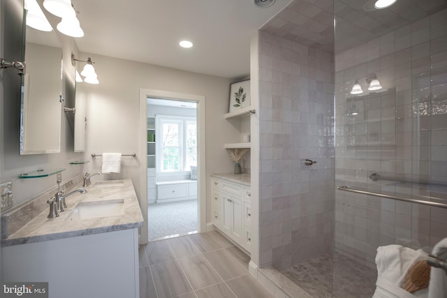 bathroom with tiled shower, tile floors, and vanity