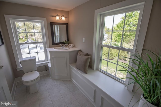 bathroom with toilet, tile flooring, and vanity