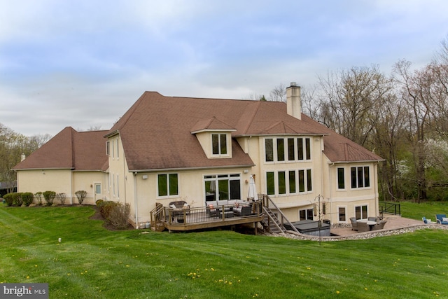 rear view of house with a patio, a yard, and a wooden deck