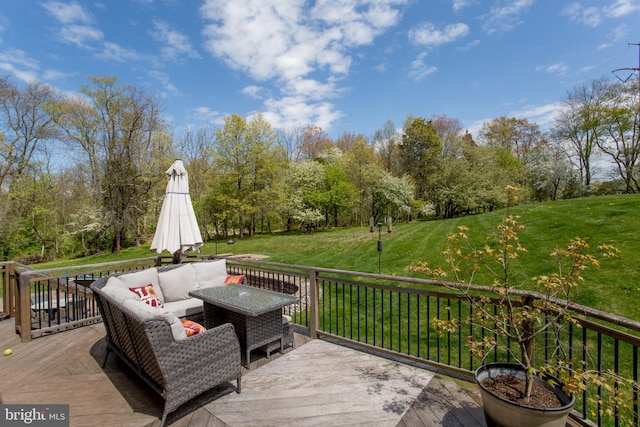 wooden deck featuring an outdoor hangout area and a lawn