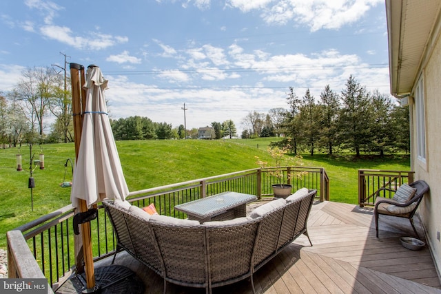 wooden terrace with a lawn