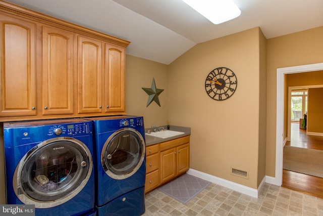 laundry room with sink, separate washer and dryer, cabinets, and light hardwood / wood-style floors