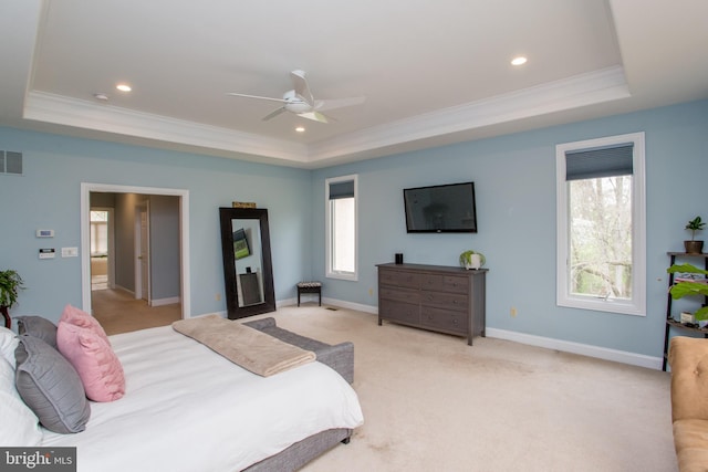 carpeted bedroom featuring ornamental molding, ceiling fan, and a raised ceiling