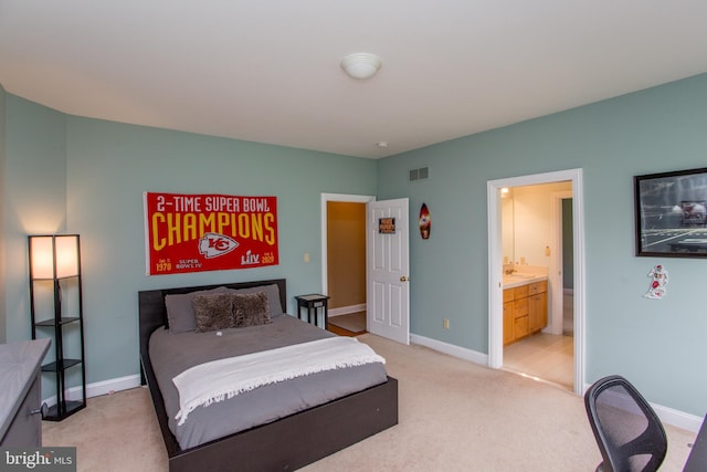 carpeted bedroom with ensuite bath