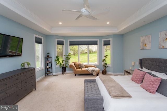 bedroom featuring light carpet, ceiling fan, a raised ceiling, and ornamental molding