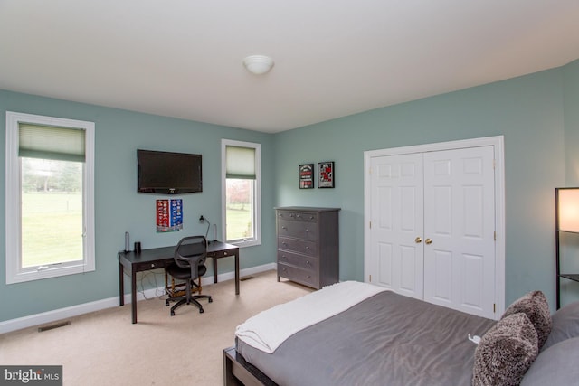 carpeted bedroom featuring a closet