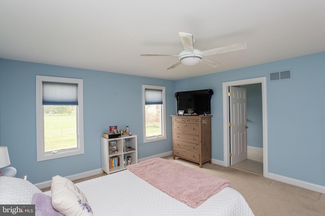 bedroom featuring light carpet and ceiling fan