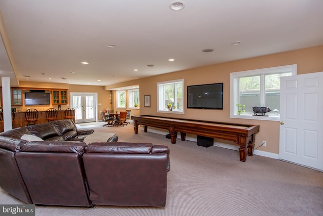 living room with pool table, light carpet, and french doors