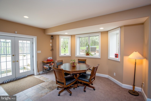 dining area featuring light tile patterned flooring and french doors