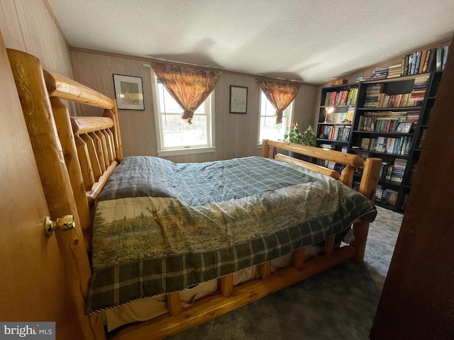 carpeted bedroom with a textured ceiling and lofted ceiling