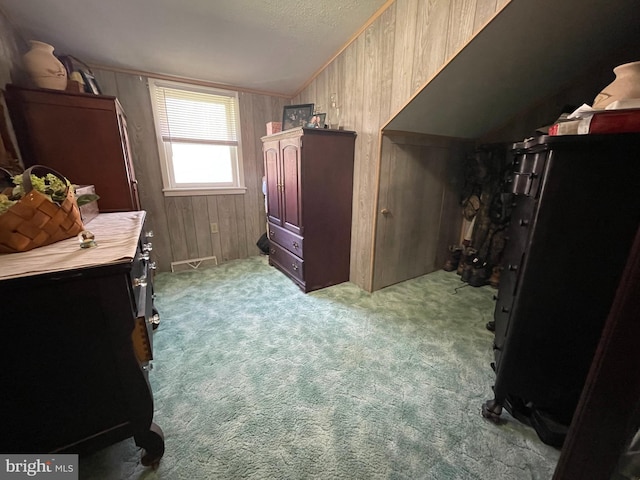 carpeted bedroom featuring wood walls