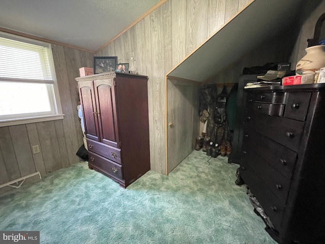 carpeted bedroom featuring wood walls