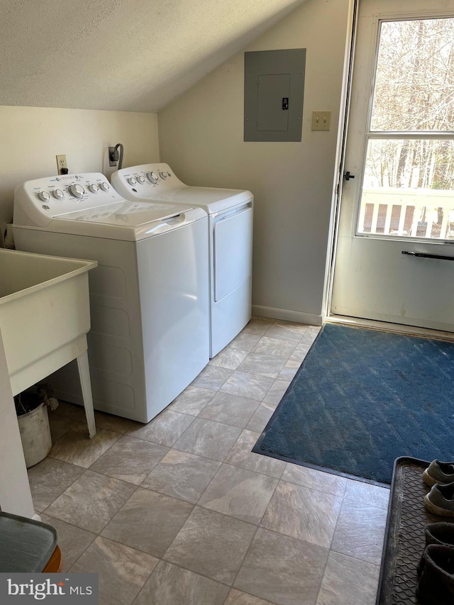 laundry room featuring hookup for an electric dryer, washing machine and clothes dryer, light tile floors, and a textured ceiling