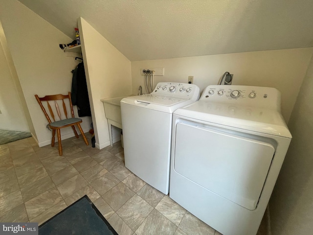 clothes washing area with electric dryer hookup, separate washer and dryer, hookup for a washing machine, light tile floors, and a textured ceiling