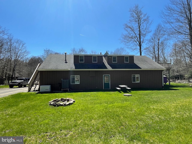 back of house with a lawn