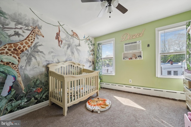 bedroom with ceiling fan, a baseboard radiator, carpet floors, and a nursery area