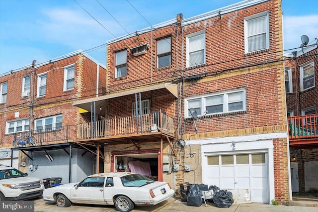 view of front facade with a garage and a balcony