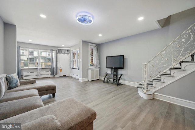 living room featuring hardwood / wood-style flooring, a baseboard heating unit, and radiator heating unit