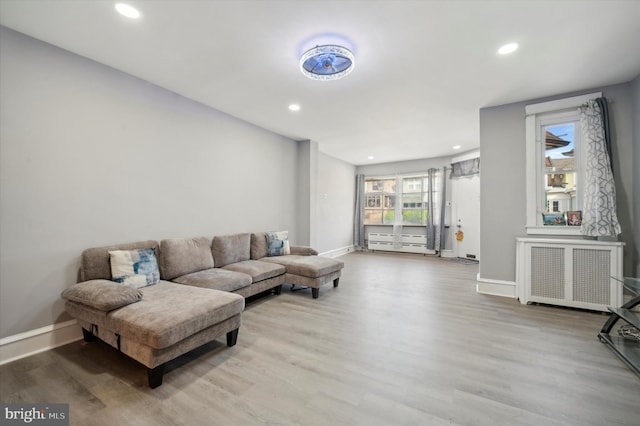 living room featuring hardwood / wood-style flooring and radiator