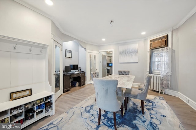 dining area with radiator heating unit, light hardwood / wood-style floors, and ornamental molding