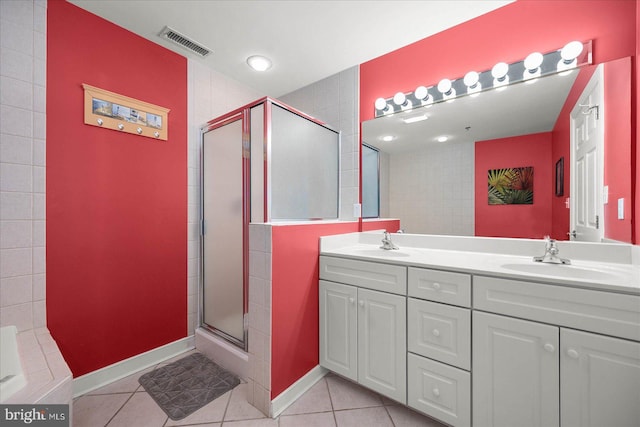 bathroom with walk in shower, tile flooring, and double sink vanity