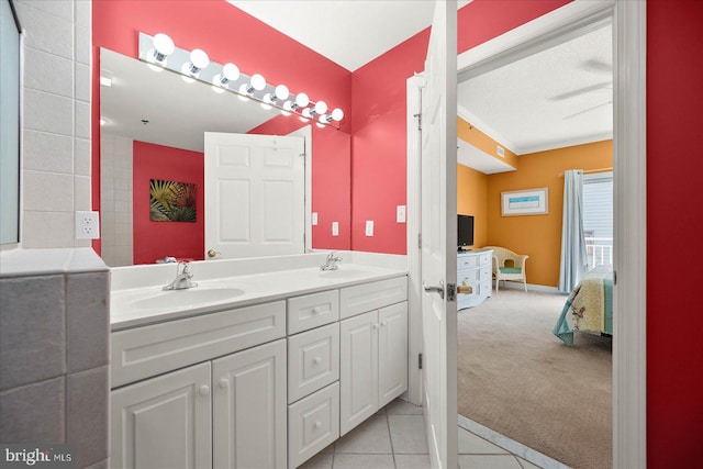 bathroom featuring dual sinks, a textured ceiling, tile flooring, and vanity with extensive cabinet space