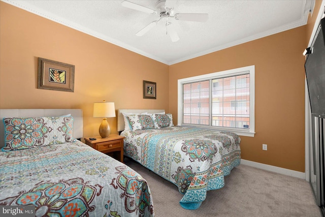 carpeted bedroom with a textured ceiling, ceiling fan, and ornamental molding