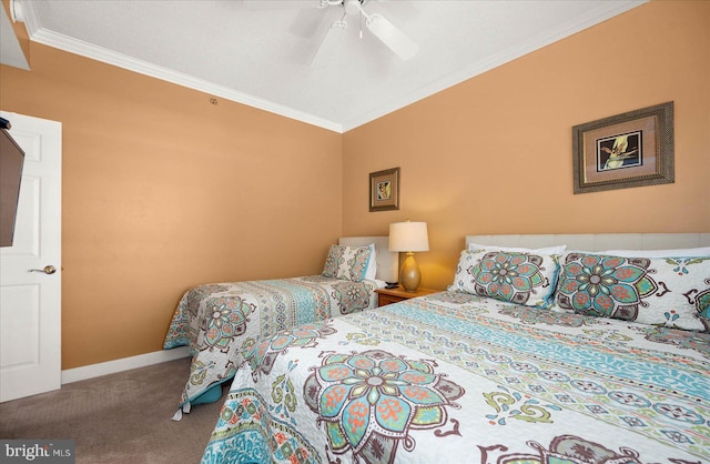 carpeted bedroom with ceiling fan and ornamental molding