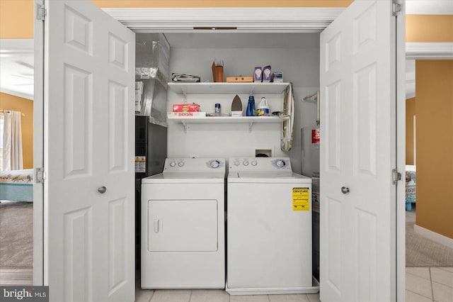 washroom with light colored carpet, washer hookup, and washer and clothes dryer