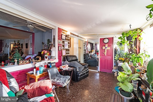 interior space with ceiling fan and ornamental molding