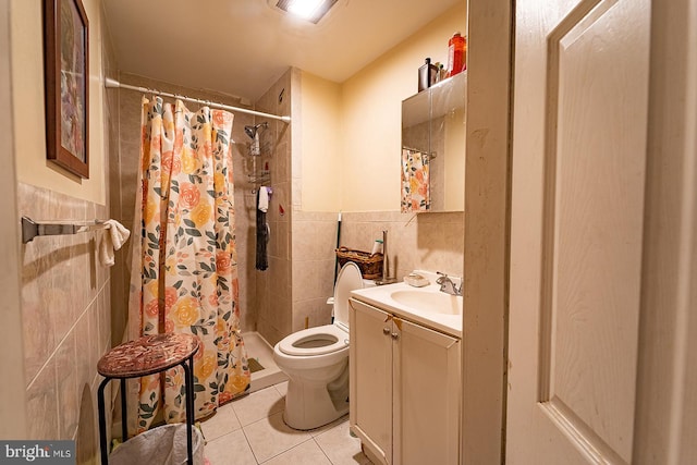 bathroom with tile floors, toilet, oversized vanity, and tile walls