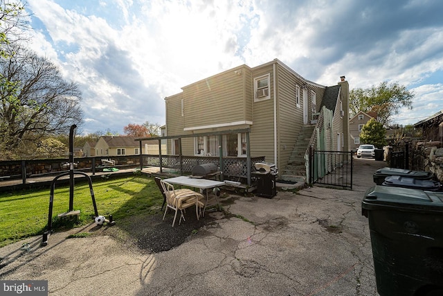 exterior space featuring a patio area and a lawn