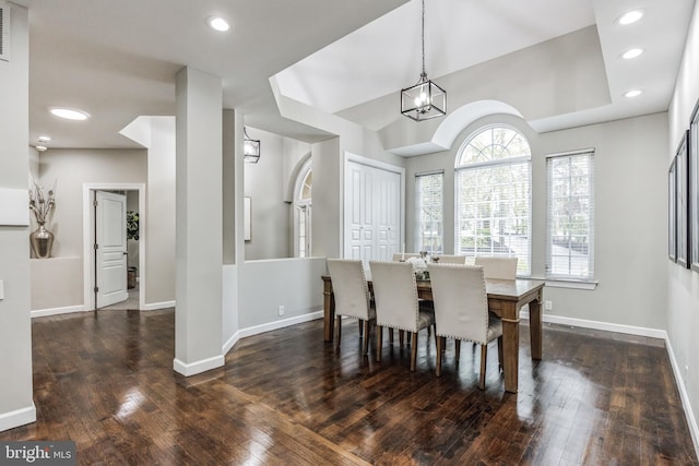 dining area with a chandelier and dark hardwood / wood-style flooring