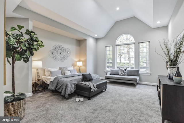 carpeted bedroom featuring high vaulted ceiling