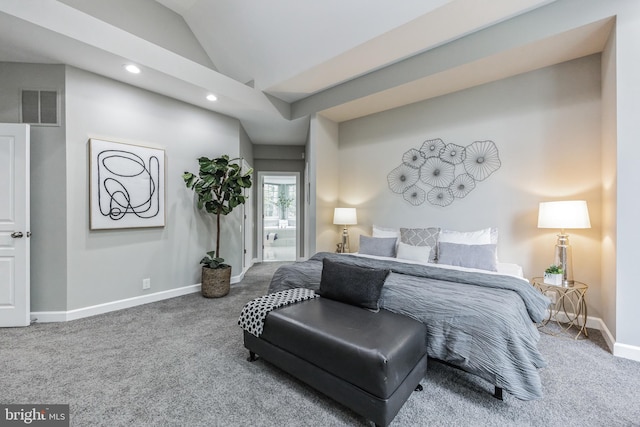 carpeted bedroom with vaulted ceiling and ensuite bathroom