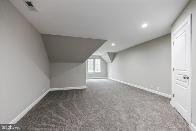 bonus room featuring carpet floors and vaulted ceiling