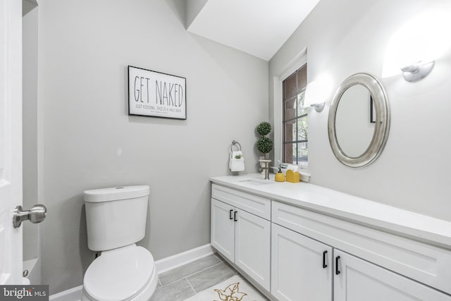 bathroom featuring vanity, toilet, and tile flooring