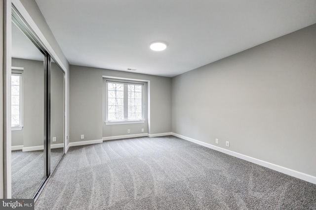 unfurnished bedroom featuring a closet and carpet flooring