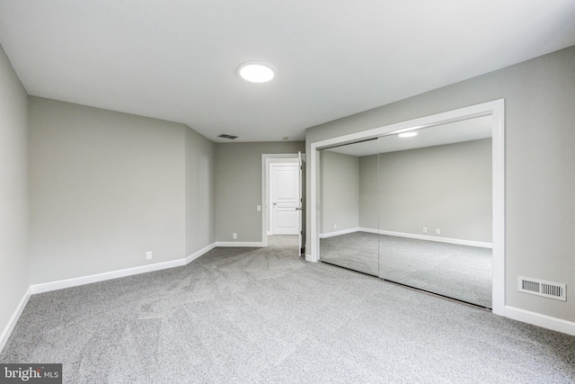 unfurnished bedroom featuring a closet and carpet