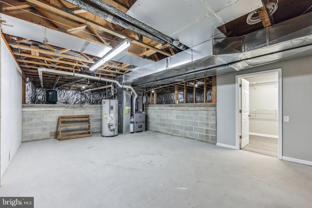 basement featuring water heater and heating utilities