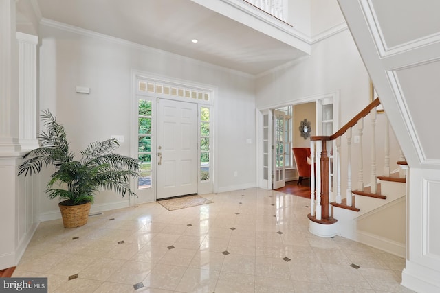 foyer entrance featuring ornamental molding and light wood-type flooring