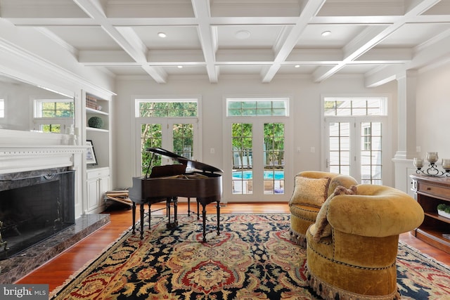 living room with french doors, a fireplace, and coffered ceiling