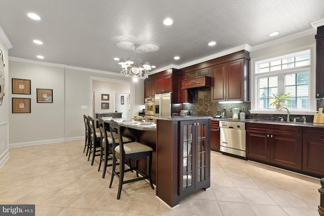 kitchen featuring appliances with stainless steel finishes, custom exhaust hood, sink, a center island, and ornamental molding