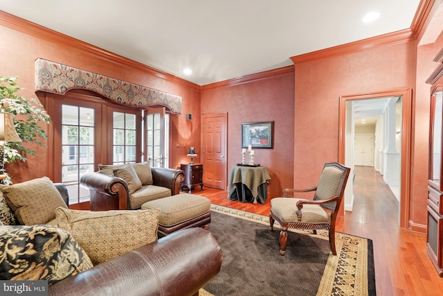 living room featuring wood-type flooring and crown molding